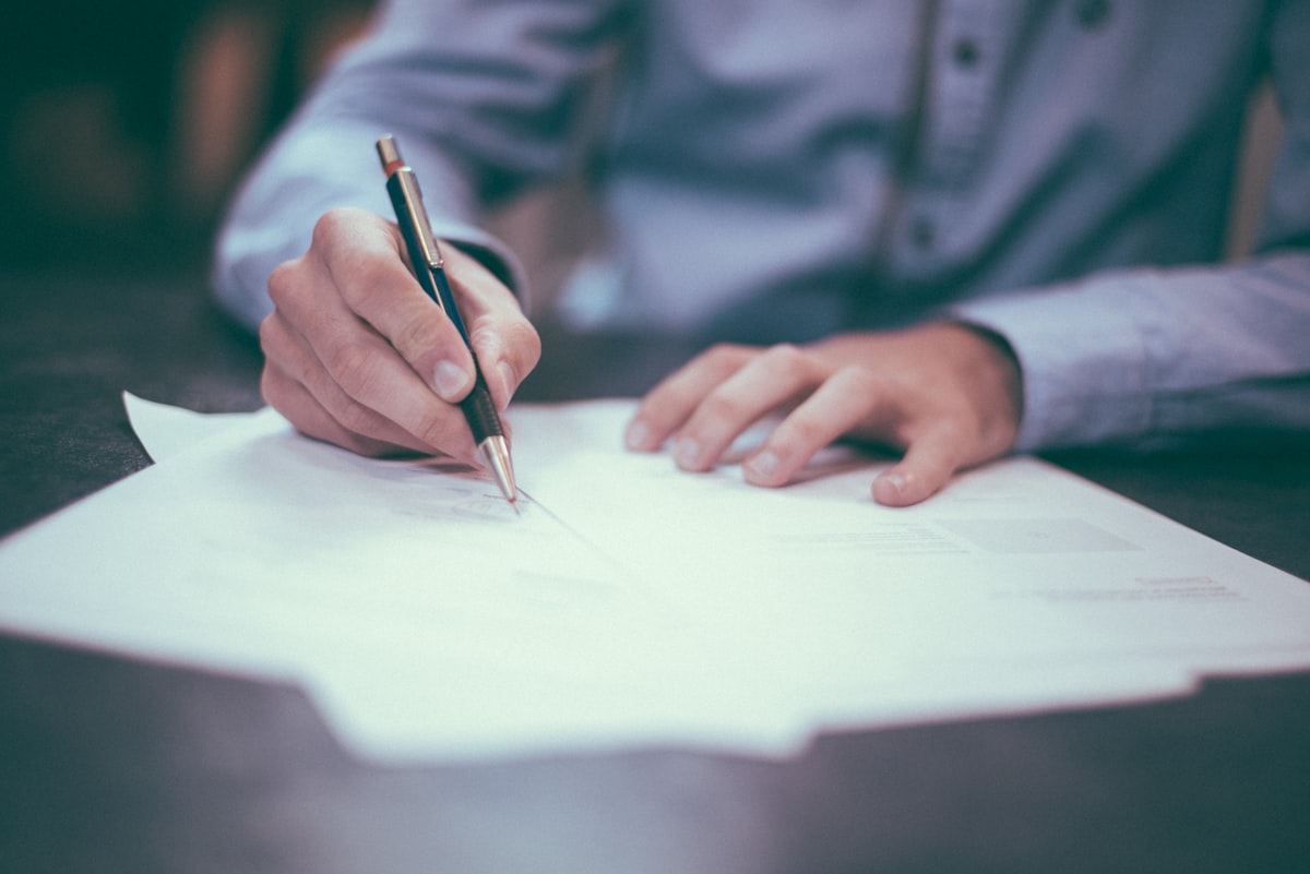 Consultant reviewing financial papers with a client at a table